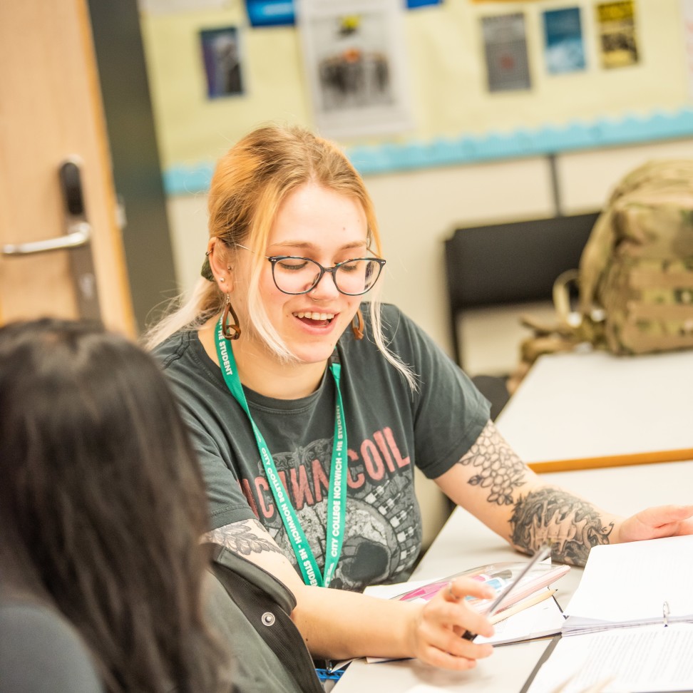 Two Higher Education students discussing their work.